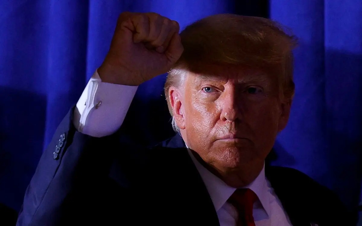 ‘It was worth it’: man arrested for crossing Trump’s road with ‘Lock him up’ sign