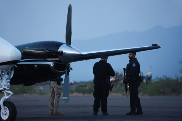 CBP agents stand next to a plane believed to be carrying drug trafficker Ismael "El Mayo" Zambada and Joaquin Guzman Lopez, the son of Zambada